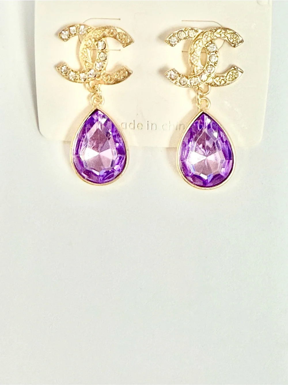 Classic and timeless Gold Logo Earrings with Purple Teardrops